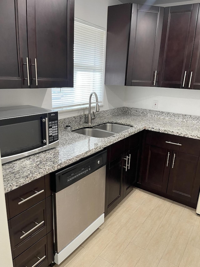 kitchen featuring dark brown cabinets, stainless steel appliances, and sink