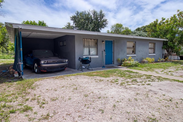 ranch-style home featuring a carport