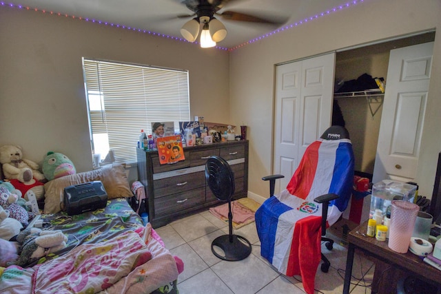 tiled bedroom featuring a closet and ceiling fan