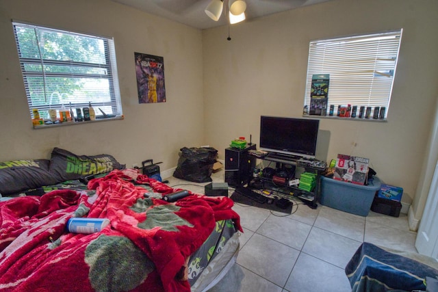 tiled bedroom featuring ceiling fan