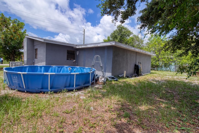 rear view of property featuring a yard