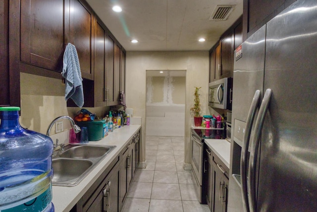 kitchen featuring light tile patterned flooring, sink, and appliances with stainless steel finishes