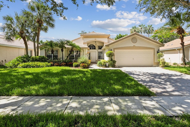 mediterranean / spanish-style home with a garage and a front lawn