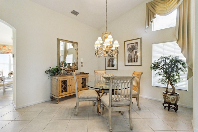 tiled dining space with vaulted ceiling and a notable chandelier