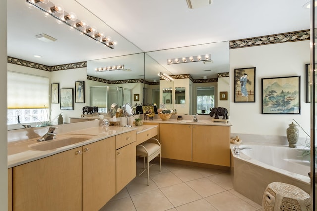 bathroom featuring plus walk in shower, vanity, tile patterned floors, and a wealth of natural light