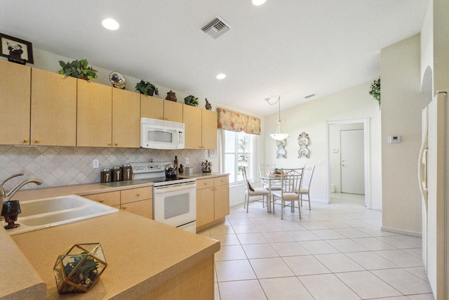 kitchen with sink, hanging light fixtures, lofted ceiling, white appliances, and light brown cabinetry