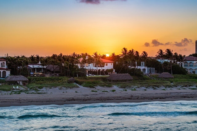 exterior space with a water view and a beach view