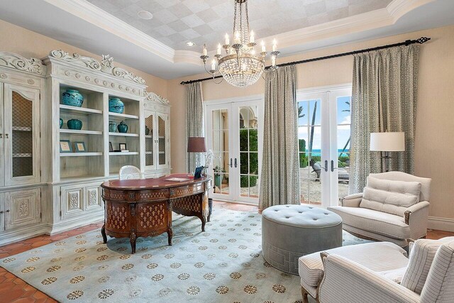 office area featuring an inviting chandelier, french doors, crown molding, and a tray ceiling