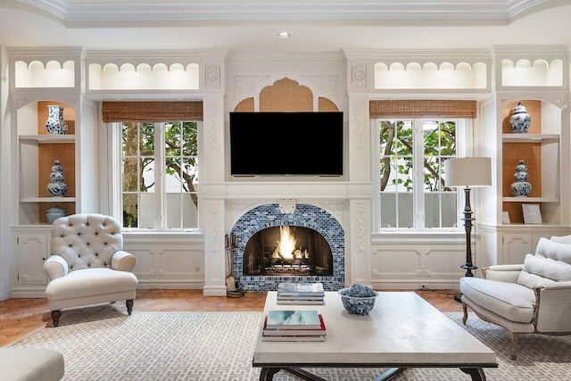 living room featuring built in features and ornamental molding