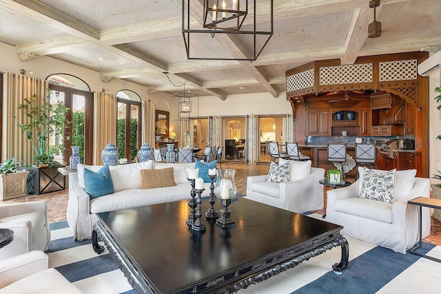 interior space with beam ceiling, an AC wall unit, coffered ceiling, and an inviting chandelier