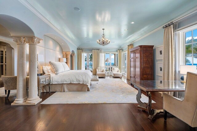 bedroom with ornate columns, dark hardwood / wood-style flooring, an inviting chandelier, and crown molding