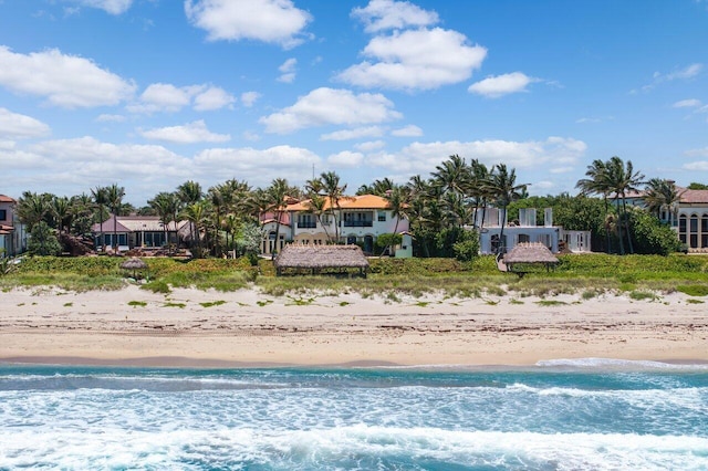 exterior space featuring a water view and a view of the beach