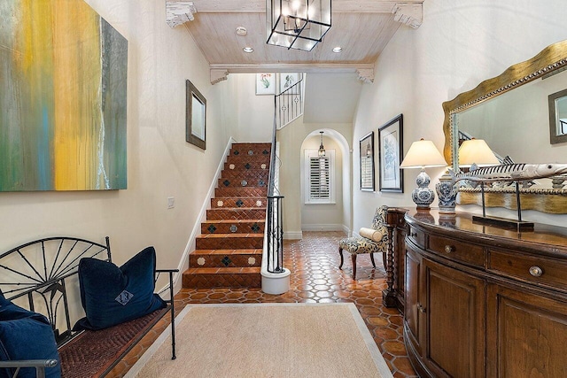 entrance foyer with tile patterned flooring and wood ceiling