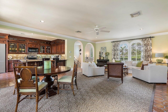 dining room featuring ceiling fan and ornamental molding