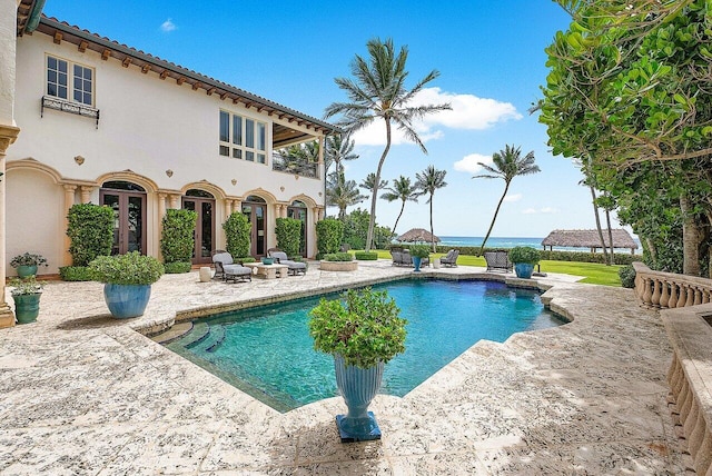 view of swimming pool featuring an outdoor living space and a patio area