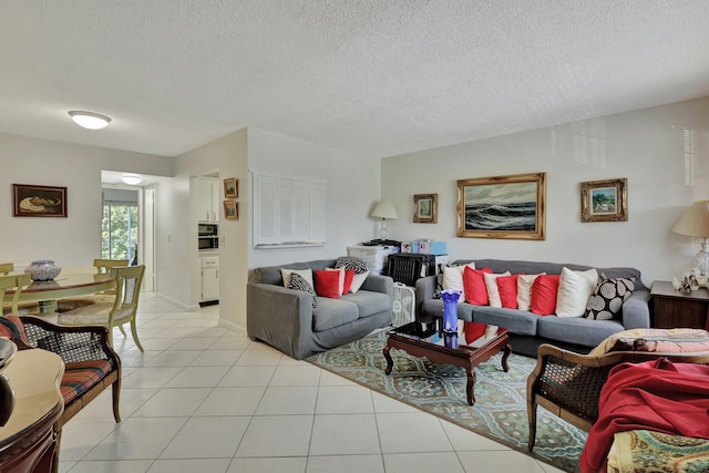 tiled living room featuring a textured ceiling