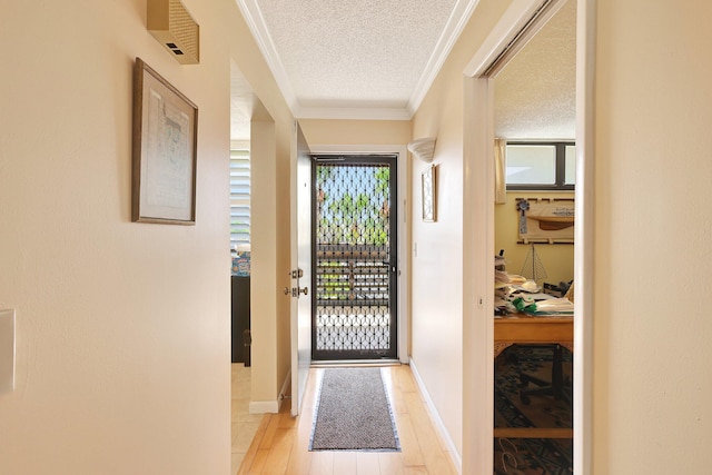 doorway to outside featuring crown molding, a textured ceiling, and light hardwood / wood-style flooring