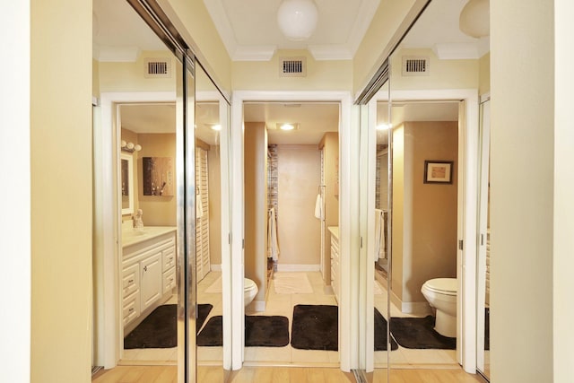 hallway featuring light hardwood / wood-style floors and ornamental molding