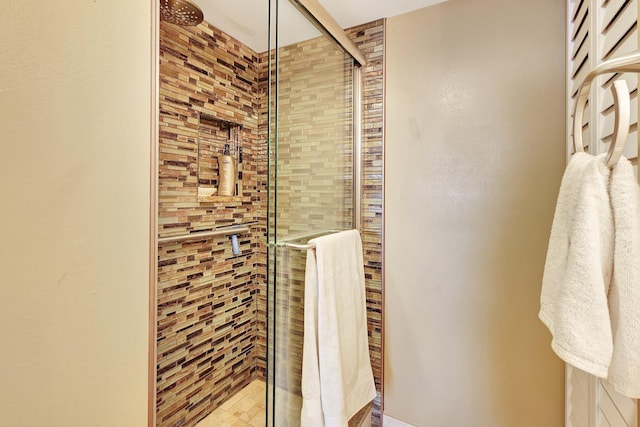 bathroom featuring a shower with door