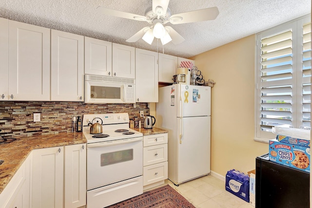 kitchen featuring decorative backsplash, white appliances, ceiling fan, light tile patterned floors, and white cabinetry