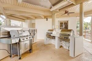 view of patio with a grill, ceiling fan, and an outdoor kitchen