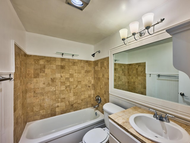 full bathroom with vanity, tiled shower / bath combo, and toilet