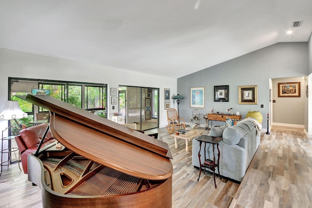 living room featuring light hardwood / wood-style flooring and lofted ceiling