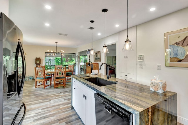 kitchen with white cabinets, stainless steel refrigerator with ice dispenser, decorative light fixtures, and dishwasher