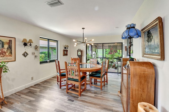 dining area featuring a chandelier and light hardwood / wood-style flooring