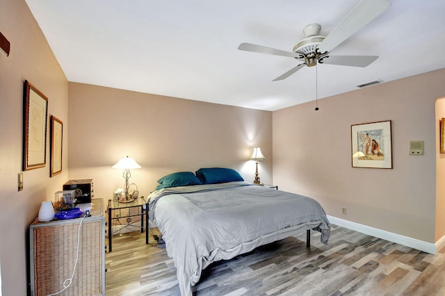 bedroom featuring hardwood / wood-style flooring and ceiling fan