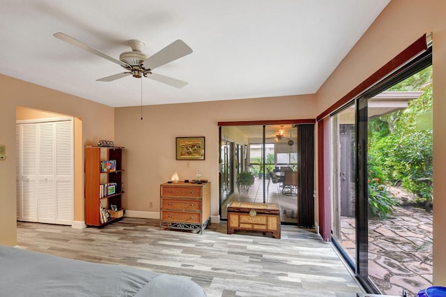 unfurnished bedroom with ceiling fan, a closet, light hardwood / wood-style flooring, and access to outside