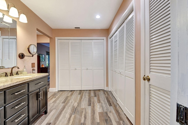 bathroom featuring vanity and hardwood / wood-style flooring