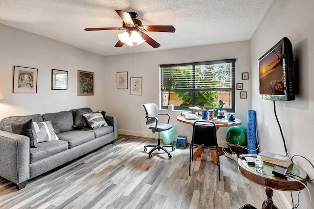 office with light wood-type flooring, a textured ceiling, and ceiling fan