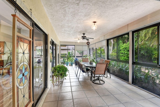 unfurnished sunroom featuring ceiling fan