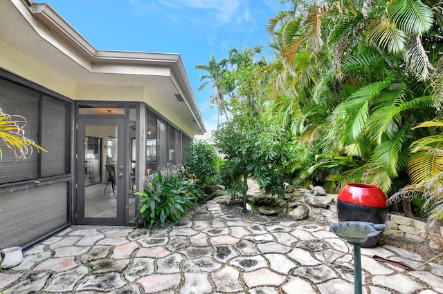 view of patio / terrace featuring a sunroom