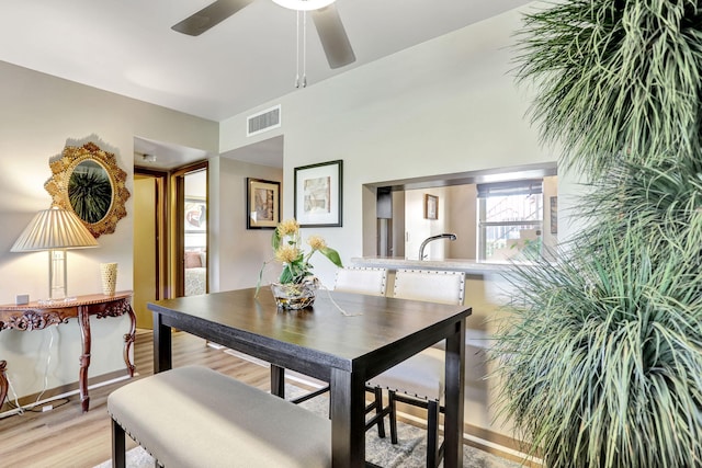 dining space with ceiling fan and light hardwood / wood-style floors