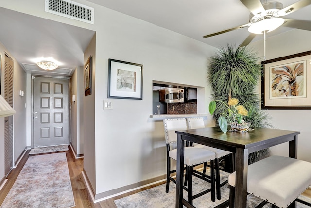 dining room featuring ceiling fan and light wood-type flooring