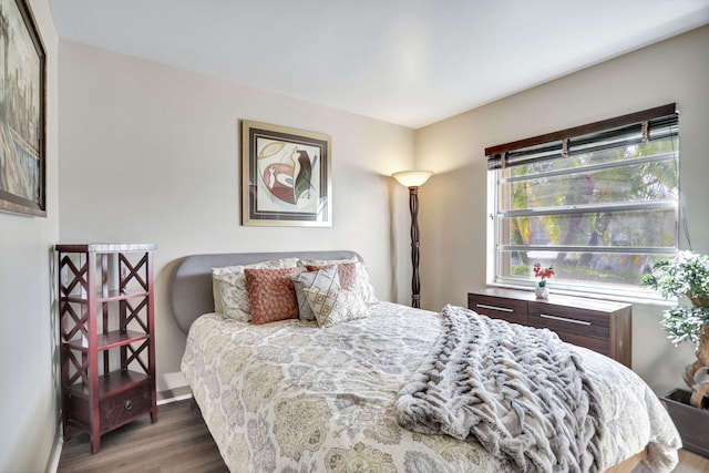 bedroom with dark hardwood / wood-style floors