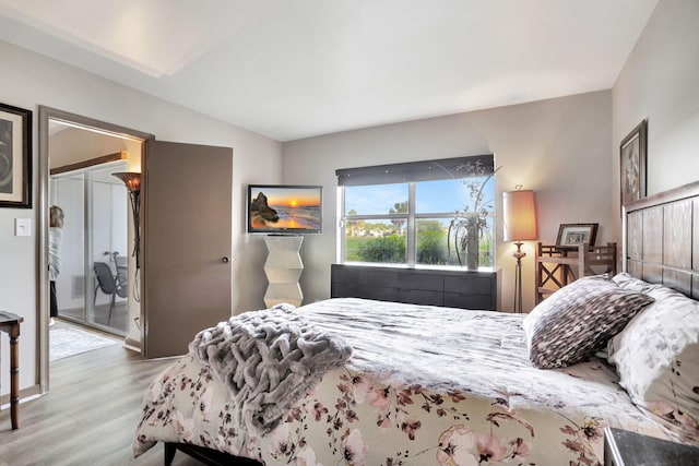 bedroom with a closet and light hardwood / wood-style floors