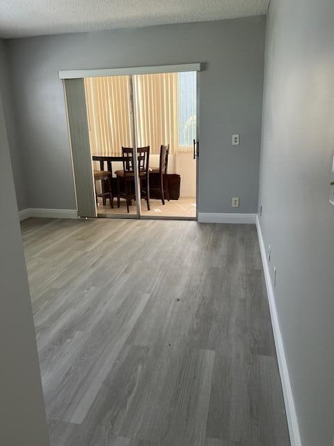 spare room featuring a textured ceiling and hardwood / wood-style floors