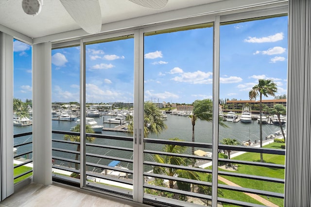 unfurnished sunroom featuring plenty of natural light and a water view