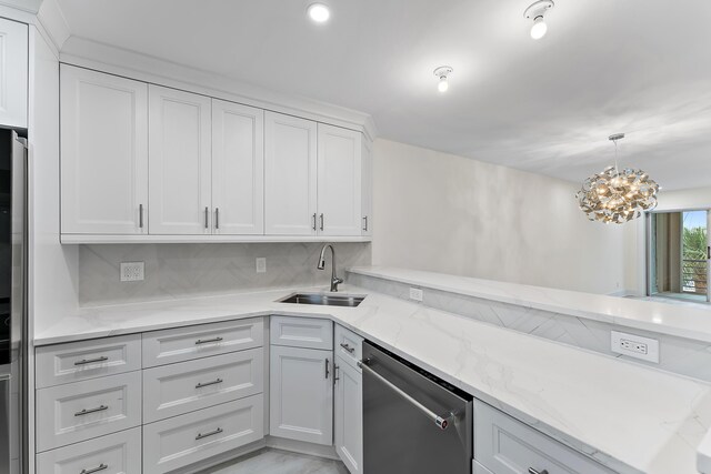 kitchen featuring white cabinetry, decorative backsplash, light stone counters, light hardwood / wood-style flooring, and refrigerator