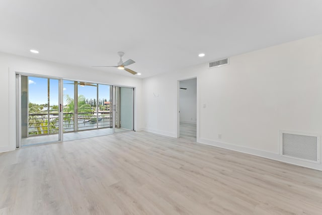 empty room featuring ceiling fan and light wood-type flooring