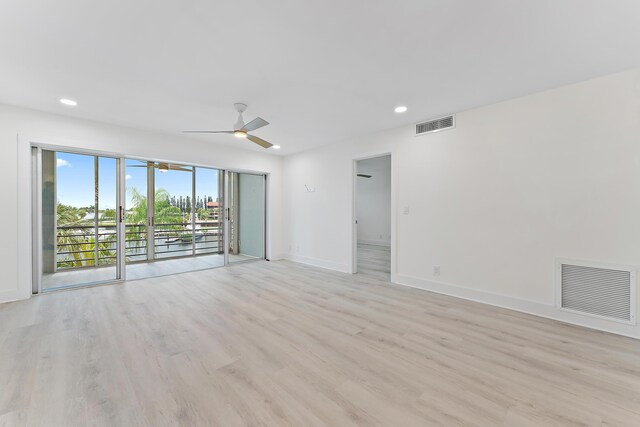 empty room featuring light wood-type flooring and ceiling fan