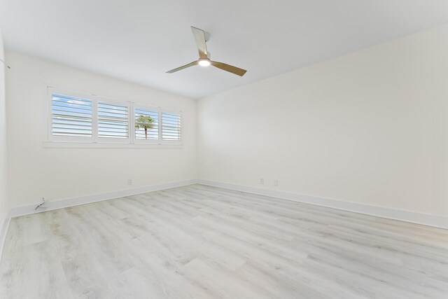 unfurnished bedroom with a spacious closet, ensuite bath, ceiling fan, and light hardwood / wood-style floors