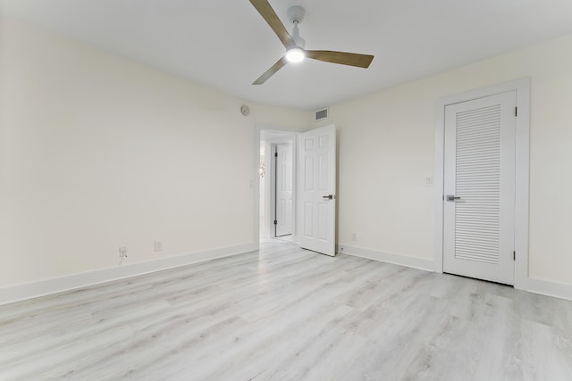 unfurnished bedroom featuring light hardwood / wood-style floors, a closet, and ceiling fan