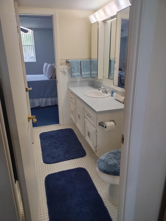 bathroom featuring vanity, toilet, and tile patterned flooring