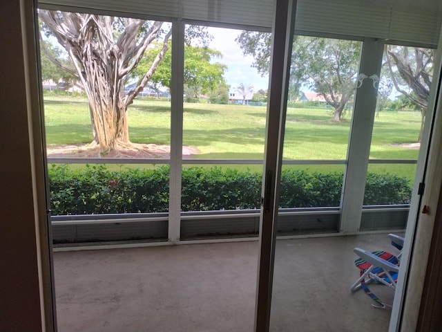 doorway to outside featuring a wealth of natural light and concrete floors