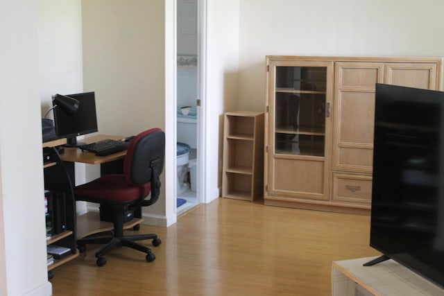 home office with light hardwood / wood-style floors