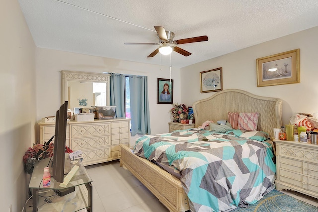 tiled bedroom with a textured ceiling and ceiling fan